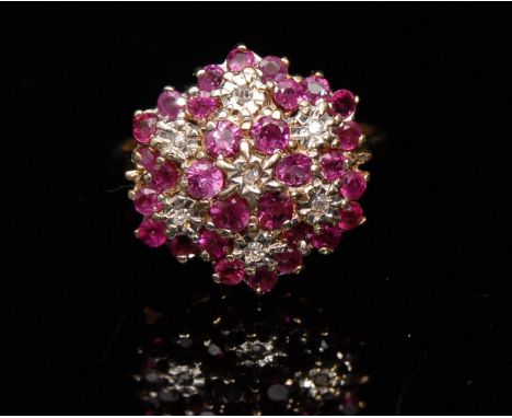 A new ruby and diamond flower head cluster ring, seven flower head  cluster, each set with a central diamond surrounded by a 