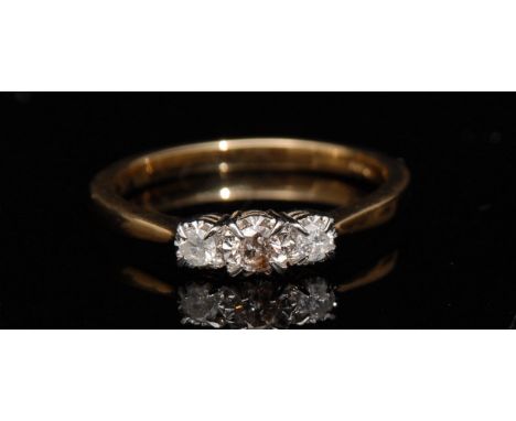 A new three stone diamond ring, central round brilliant cut diamond, flanked by two smaller diamonds, total diamond weight ap