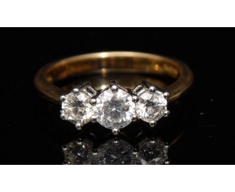 A diamond three stone ring, three round brilliant cut diamonds, total diamond weight approx 1.0ct, 18ct white gold claws, 18c