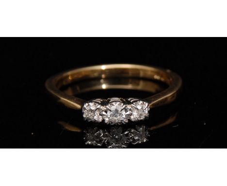 A new three stone diamond ring, central round brilliant cut diamond, flanked by two smaller diamonds, total diamond weight ap