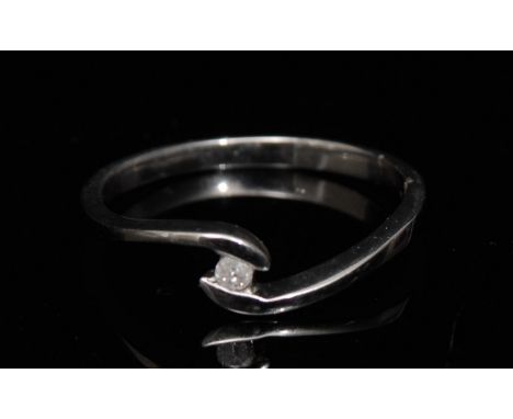 A new solitaire diamond ring, round brilliant cut diamond, approx 0.05ct, open 9ct white gold setting, 9ct white gold shank, 