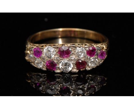 A ruby and diamond twelve stone panel ring, the marquise panel set with six pale pink ruby's and six graduated old brilliant 