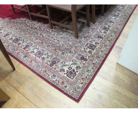 A GOOD LARGE WOOL CARPET the central ivory and maroon central medallion flanked by a six stripe border 322cm x 405cm (A/F)