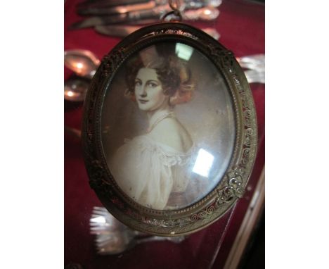 A CONTINENTAL MINIATURE OIL PORTRAIT OF A YOUNG LADY