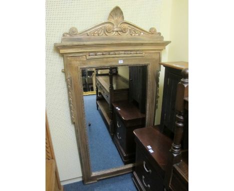 A CONTINENTAL GILTWOOD AND GESSO MIRROR of architectural outline the bevelled glass plate within an egg and dart moulded fram