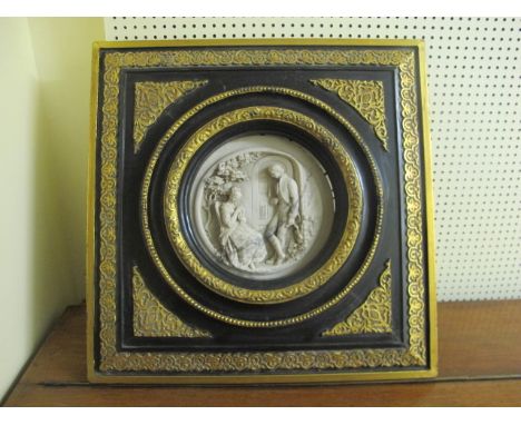 A PAIR OF COMPOSITION PLAQUES each moulded in relief with figures within an ebonised and gilt frame 43cm x 37cm