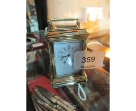 A MINIATURE BRASS AND ENAMEL CARRIAGE CLOCK