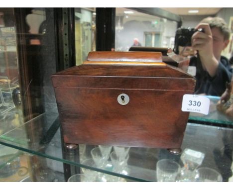A VICTORIAN MAHOGANY TEA CADDY of rectangular tapering form the hinged lid containing compartments raised on bun feet