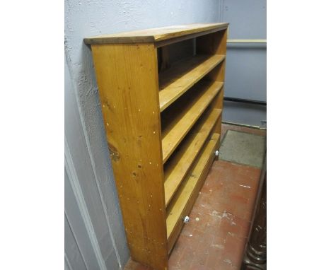A PINE FOUR SHELF STANDING BOOKCASE with drawer below 129cm (h) x 133cm (w)
