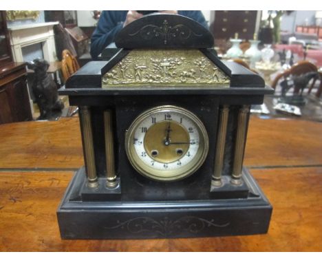 A BLACK SLATE AND BRASS MANTLE CLOCK of architectural outline with enamel and brass dial between reeded columns 36cm (h) x 36