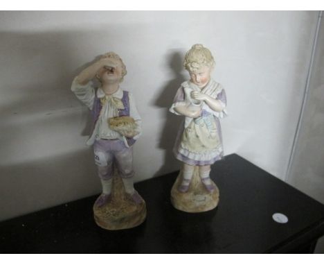 A PAIR OF BISQUE FIGURES modelled as a young girl and her companion she holding a conch shell he eating fruit each shown stan