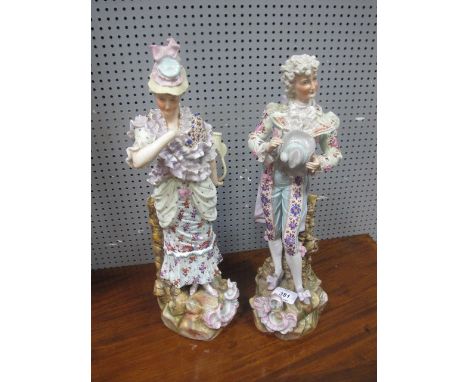 A PAIR OF CONTINENTAL PORCELAIN HAND PAINTED FIGURES modelled as a Gentleman and his companion she holding a basket he holdin