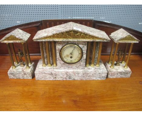 A MOTTLED MARBLE CLOCK SUITE the clock with arched pediment and Corinthian columns flanked by a pair of classical figures in 
