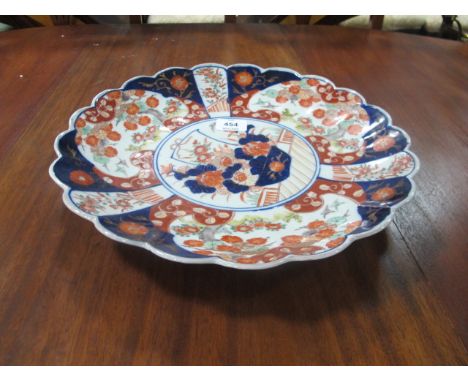 AN IMARI DISH with lobed rim and floral decoration