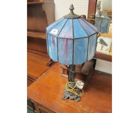 A BRONZE FIGURAL TABLE LAMP with Tiffany style shade 59cm high