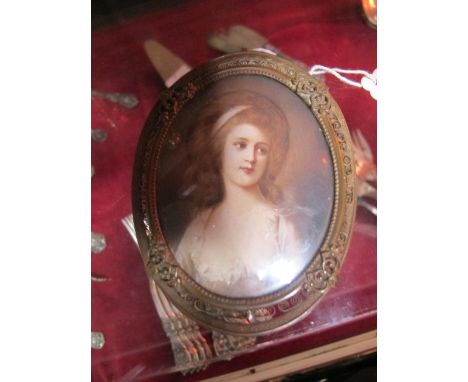 A CONTINENTAL MINIATURE OIL PORTRAIT OF A YOUNG LADY