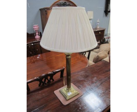 A CORINTHIAN COLUMN BRASS TABLE LAMP with pleated shade