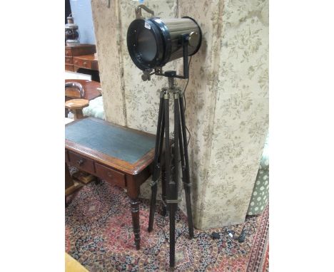A TRIPOD MOUNTED STANDING LAMP with brass mounts