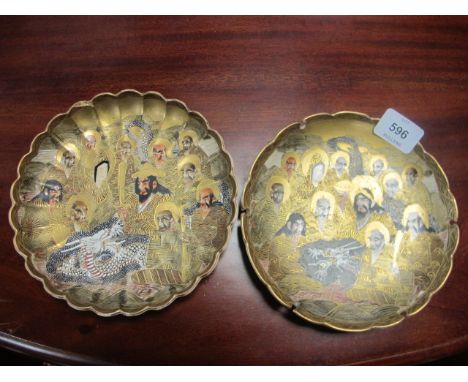 A PAIR OF SATSUMA PLATES each with a gilt ground decorated with figures and dragons 18cm diameter