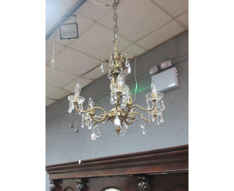A GILT METAL SIX BRANCH CHANDELIER the central stem decorated with figures and pear shaped drops