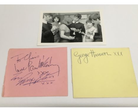 Three original Beatles signatures comprising Paul McCartney, George Harrison and Ringo Starr. The autographs were obtained by