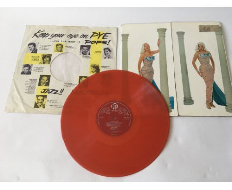 A collectable Diana Dors LP 'Swingin Dors' on red vinyl. Vinyl has light surface and spindle marks.