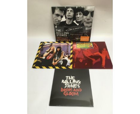 Four Rolling Stones vinyl records comprising 'Totally Stripped' (DVD and 2LP set), 'Dirty Work' LP (both sealed), 'No Securit