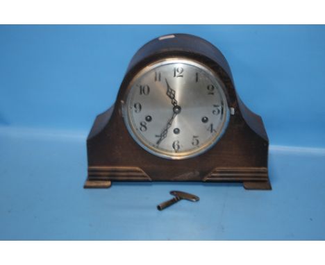 AN OAK MANTEL CLOCK WITH KEY