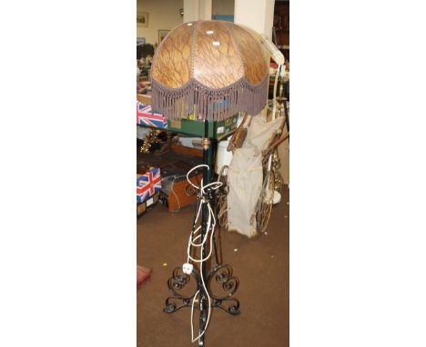 A STANDARD LAMP WITH SHADE