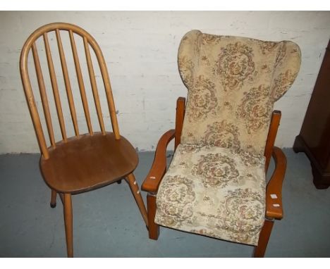 A WOODEN RECLINER CHAIR AND AN ERCOL STYLE STICK BACK CHAIR