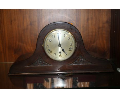 AN OAK MANTEL CLOCK