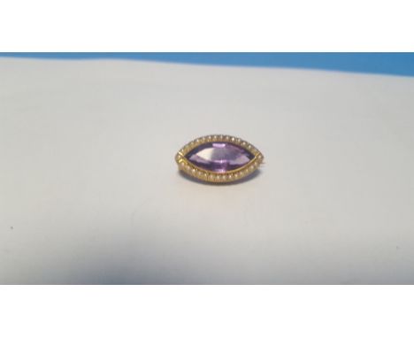 A 9 CT GOLD AMETHYST AND SEED PEARL GALLERY MOUNTED BROOCH. Approx. weight 3.1 g, width 2.5 cm