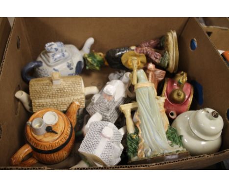 A TRAY OF CERAMIC TEAPOTS, VASES, AND ORNAMENTS