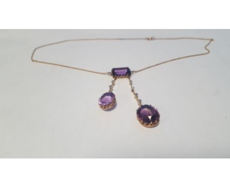 AN UNUSUAL ANTIQUE AMETHYST AND DIAMOND NECKLACE, featuring a rectangular amethyst above two oval amethyst and diamond droppe