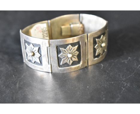 A Mexican silver six panel articulated bracelet having embossed decoration and concealed clasp, approx 60g
