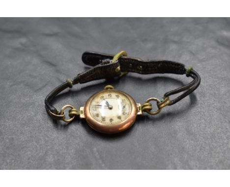 A lady's vintage 9ct rose gold wrist watch having Arabic numeral dial with subsidiary seconds in a plain circular case on a b