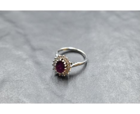 A ruby and diamond cluster ring in a claw set stepped mount on an 18ct white gold loop, size M &amp; approx 4.9g