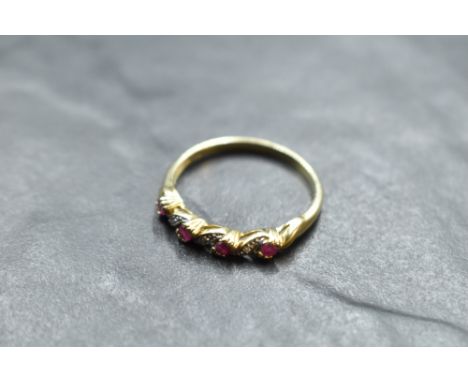 A ruby and diamond chip twist ring on a 9ct gold loop, size T and approx 2.2g