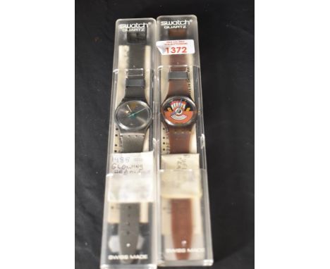A Swatch 'Glowing Arrow' , with plastic case, original sales receipt and associated guarantee. Sold together with a Swatch 'R
