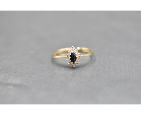 A small sapphire and diamond oval cluster ring on a 9ct gold loop, size P &amp; approx 1.4g