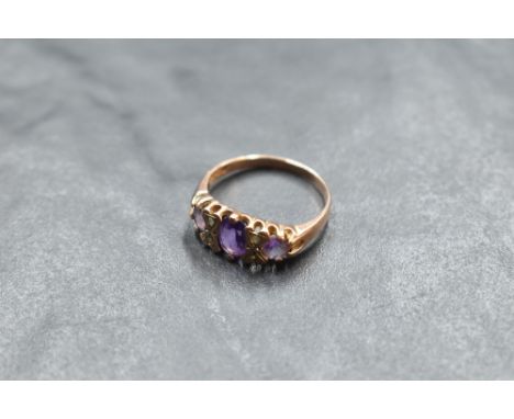 A three stone amethyst ring having diamond chip spacers in a gallery mount on a 9ct rose gold loop, size O &amp; approx 2.4g