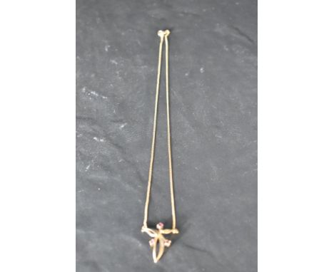 A 9ct gold knot style pendant with ruby detail and a fixed chain, approx 16' &amp; 2.7g