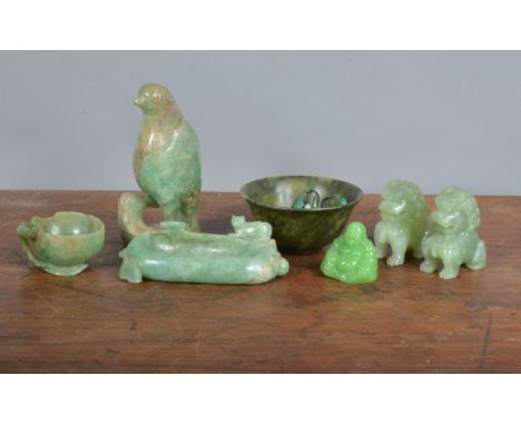 A collection of hard stone and jadeite carved figures,&nbsp; to include a parrot, 14cm high, a trough with a sitting cat, two