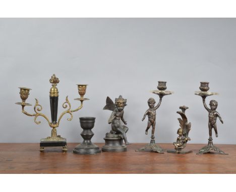 A pair of 19th century and later spelter cherub candlesticks, both 23cm high, two cherub sculptures, one spelter the other br