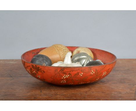 A collection of fruit,&nbsp; in various hardstone, ceramic and enamel bodies, presented in a papier mache bowl, the onyx pump