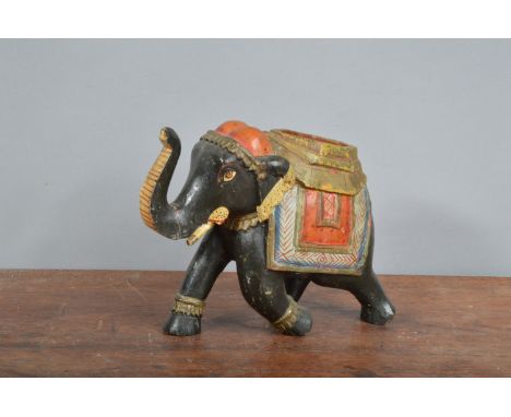 A wooden Indian elephant,  hand-carved and hand-painted. 16 cm tall. Break to trunk and minor wear. (1) 