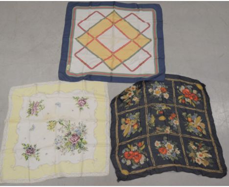 Three silk scarves, of differing sizes and styles, one marked Celine, Paris, with wear and stains AF (3) 