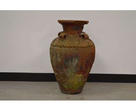 A terracotta amphora shaped garden urn,  with incised geometric decoration of flowers. 70 cm tall.  Some wear and weathering.