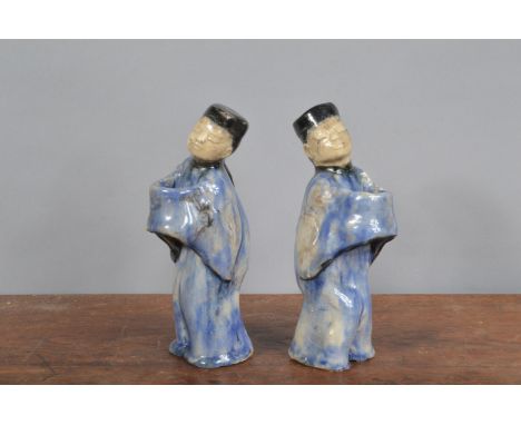 A pair of early 20th century Chinese ceramic figurines, possibly for offerings, crazing to the glaze and further damage comme