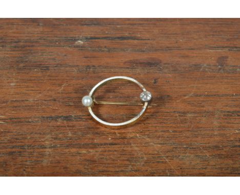 An enamel seed pearl and diamond circular brooch,  2 cm in diameter, enamel (af) 